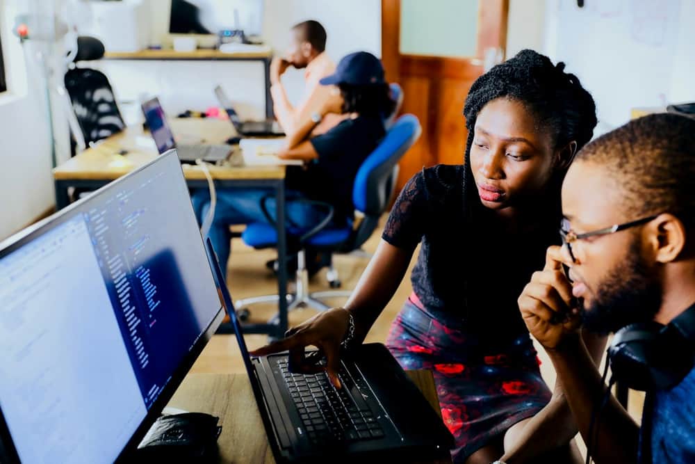 Team completing an online course together on a laptop